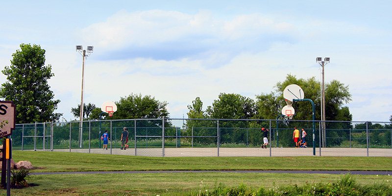 Outdoor basketball courts at public park lit by ACP LED floodlights.