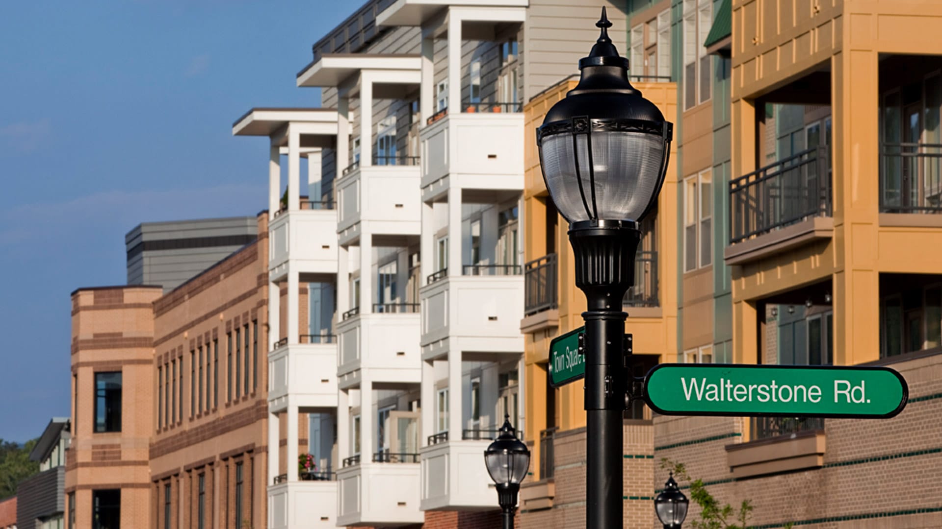 Street in front of residential condos lined with Holophane's LED post-top acorn lights.