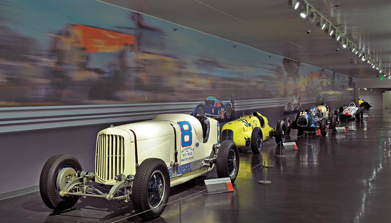 Juno Trac-Master track lighting system illuminates retired racecars in museum.
