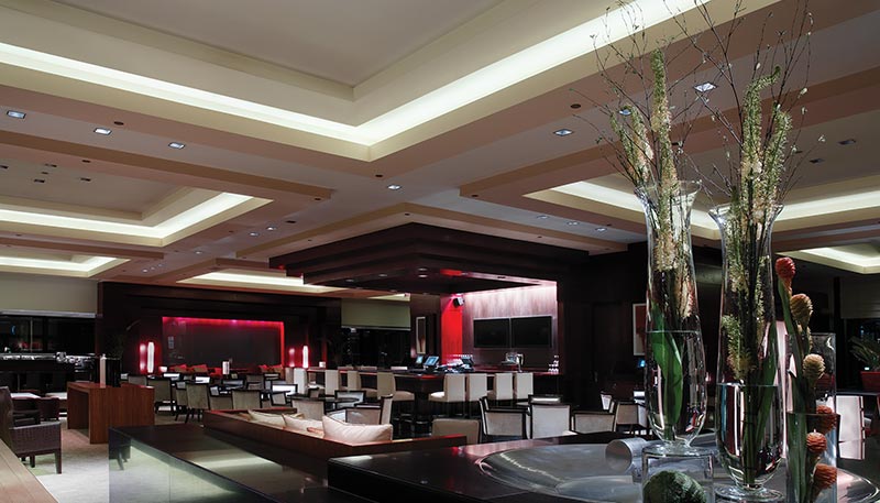 Juno Trac 12 linear LED modules illuminate a dim restaurant dining area.