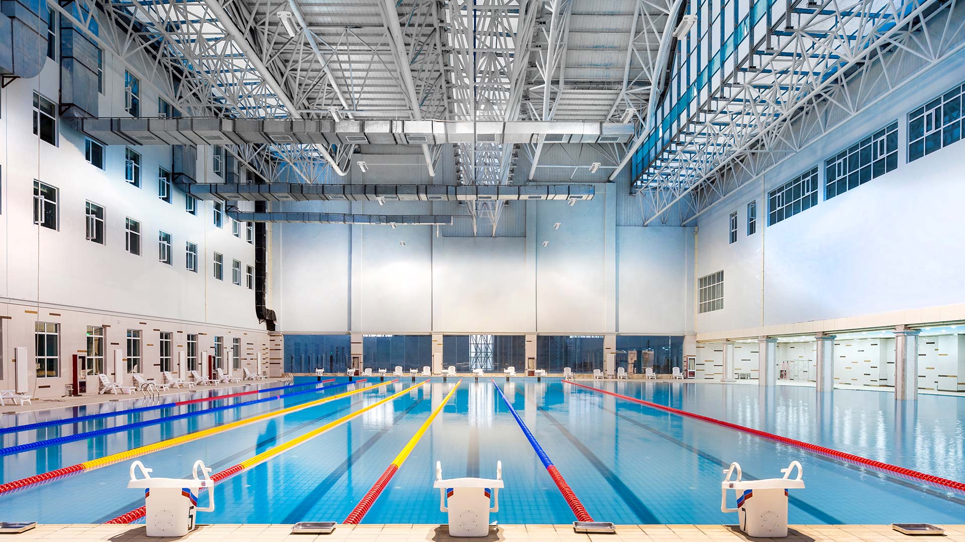 Lithonia’s Beyond Linear LED High Bays lights indoor pool area 