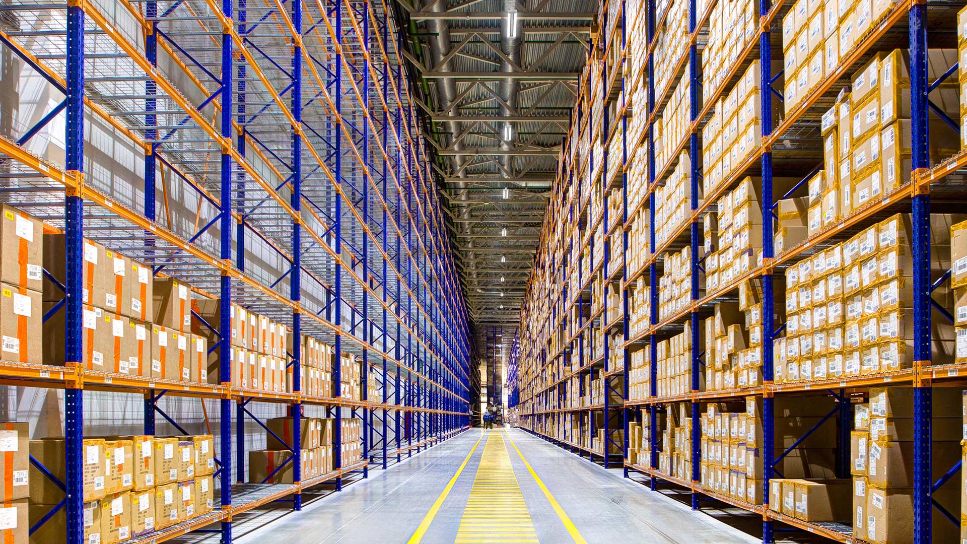 Clean and organized warehouse storage area illuminated by Beyond Linear High Bays from Lithonia 